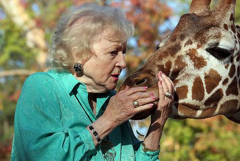 Betty White talking to giraffe